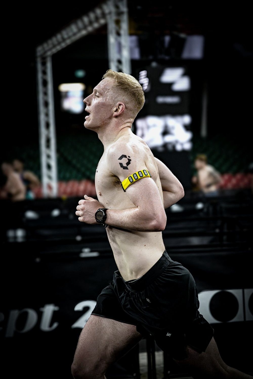 Liam McCroary racing HYROX with the Performr band on his arm